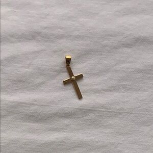 Solid 14 karat yellow gold cross with natural diamond